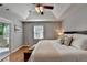 Spacious main bedroom with tray ceiling, hardwood floors, and access to a private balcony at 1990 Holly Cove Rd, Cumming, GA 30040