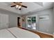 Spacious main bedroom with tray ceiling, hardwood floors, and balcony access at 1990 Holly Cove Rd, Cumming, GA 30040