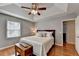 Spacious main bedroom with tray ceiling, hardwood floors, and a sitting area at 1990 Holly Cove Rd, Cumming, GA 30040