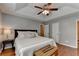 Spacious main bedroom with tray ceiling, hardwood floors, and night stand with lamp at 1990 Holly Cove Rd, Cumming, GA 30040