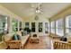 Cozy sunroom filled with natural light from the many windows overlooking greenery at 1990 Holly Cove Rd, Cumming, GA 30040