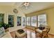 Bright sunroom with large windows, vaulted ceiling, and comfortable wicker furniture at 1990 Holly Cove Rd, Cumming, GA 30040