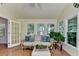 Inviting sunroom with natural light, hardwood floors, and comfortable seating at 1990 Holly Cove Rd, Cumming, GA 30040