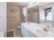 Bright bathroom with double sinks, tiled floors, and a shower-tub combo at 2325 Sailor Ln, Suwanee, GA 30024