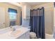 Bathroom features a white vanity, mirror, and a shower with gray curtain at 2325 Sailor Ln, Suwanee, GA 30024