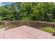 Wooden deck offering an outdoor space surrounded by greenery and a beautiful view at 2325 Sailor Ln, Suwanee, GA 30024