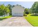 Spacious driveway leading to a two-car garage with a well-maintained lawn and landscaping at 2325 Sailor Ln, Suwanee, GA 30024