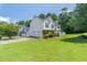 Traditional home with a well-manicured lawn, two-car garage, and charming green shutters against a light exterior at 2325 Sailor Ln, Suwanee, GA 30024