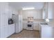 Bright kitchen features a full suite of white appliances and ample cabinet space at 2325 Sailor Ln, Suwanee, GA 30024