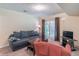 Cozy living room with a large sofa, glass doors, and direct access to the backyard at 2325 Sailor Ln, Suwanee, GA 30024
