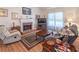 Comfortable living room featuring a cozy fireplace and a relaxing seating area at 2325 Sailor Ln, Suwanee, GA 30024