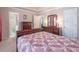 The main bedroom features a bed with a patchwork quilt and a view of the ensuite bathroom at 2325 Sailor Ln, Suwanee, GA 30024
