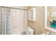 Bright bathroom featuring a white tiled shower-tub combination and neutral wall color at 7490 Hunters Ridge Dr, Douglasville, GA 30134