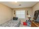 Cozy bedroom with a twin bed, neutral walls and natural light from the window at 7490 Hunters Ridge Dr, Douglasville, GA 30134