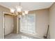 Bright dining room featuring a chandelier, carpet floors, and neutral walls at 7490 Hunters Ridge Dr, Douglasville, GA 30134
