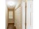 Well-lit hallway with hardwood floors and multiple closets for ample storage space, offering functionality at 7490 Hunters Ridge Dr, Douglasville, GA 30134