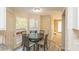 Eat-in kitchen featuring white cabinets, wood-look floors, and exterior access at 7490 Hunters Ridge Dr, Douglasville, GA 30134
