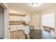 Eat-in kitchen featuring white cabinets, stainless sink, and wood-look floors at 7490 Hunters Ridge Dr, Douglasville, GA 30134