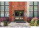 Exterior brick entryway with black trim windows, planters, and the letter E to mark the entrance at 170 Boulevard Se # 221E, Atlanta, GA 30312