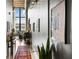 Hallway view featuring stylish decor, a vibrant rug, and natural light, creating a welcoming atmosphere at 170 Boulevard Se # 221E, Atlanta, GA 30312