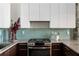 Updated kitchen showcasing stainless steel appliances, light countertops, and a tiled backsplash at 170 Boulevard Se # 221E, Atlanta, GA 30312