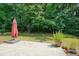 This backyard features a patio with an umbrella and views of the surrounding trees and landscaping at 2521 Eden Ridge Ln # 7, Acworth, GA 30101