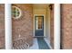 Inviting entryway featuring brick columns, a bench, round window, and a decorative front door at 2521 Eden Ridge Ln # 7, Acworth, GA 30101