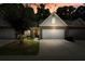 Charming brick townhome featuring a two-car garage and well-maintained landscaping under a dramatic sunset sky at 2521 Eden Ridge Ln # 7, Acworth, GA 30101
