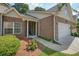 Close-up of a brick townhome with landscaped front yard, white pillars, and covered entry at 2521 Eden Ridge Ln # 7, Acworth, GA 30101