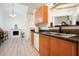 Bright kitchen featuring wood cabinets, stainless sink, and a view into the living area with fireplace at 2521 Eden Ridge Ln # 7, Acworth, GA 30101