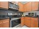 Well-lit kitchen featuring stainless steel appliances, black granite countertops, and gray tiled backsplash at 2521 Eden Ridge Ln # 7, Acworth, GA 30101