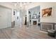Open-concept living room with hardwood floors, fireplace, and stylish wainscoting at 2521 Eden Ridge Ln # 7, Acworth, GA 30101