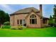 Stately brick home with large windows and well-maintained lawn, perfect for outdoor activities at 6040 Boulder Bluff Dr, Cumming, GA 30040