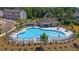 Community pool with lounge chairs and shade by lake at 67 Wilder Ridge Way, Lawrenceville, GA 30044