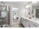 Bright bathroom with dual sinks, white cabinetry, and a view into the main bedroom at 67 Wilder Ridge Way, Lawrenceville, GA 30044