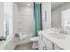 Well-lit bathroom featuring a shower-tub combo with teal curtain and white vanity at 67 Wilder Ridge Way, Lawrenceville, GA 30044
