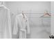 Neat walk-in closet with white shelving and white robe at 67 Wilder Ridge Way, Lawrenceville, GA 30044