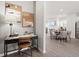 Stylish home office area with modern decor, artwork, and an open floor plan leading to dining at 67 Wilder Ridge Way, Lawrenceville, GA 30044