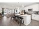 Open-concept kitchen with an island, stainless steel appliances, and modern pendant lighting at 67 Wilder Ridge Way, Lawrenceville, GA 30044