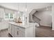 Modern kitchen featuring a large island with quartz countertops and stainless steel appliances at 67 Wilder Ridge Way, Lawrenceville, GA 30044