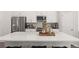 Modern kitchen island with white quartz countertop, stainless appliances, and stylish decor at 67 Wilder Ridge Way, Lawrenceville, GA 30044