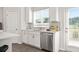Bright kitchen with white cabinets, stainless steel appliances, and natural light from the nearby door at 67 Wilder Ridge Way, Lawrenceville, GA 30044