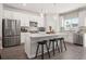 Open kitchen with stainless steel appliances, a center island, and modern white cabinets at 67 Wilder Ridge Way, Lawrenceville, GA 30044