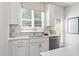 Bright white kitchen with stainless steel appliances and modern backsplash with natural light at 67 Wilder Ridge Way, Lawrenceville, GA 30044