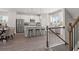 Well-lit kitchen with a central island, stainless steel appliances, and open-concept to dining area at 67 Wilder Ridge Way, Lawrenceville, GA 30044