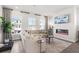 Bright living room featuring a comfortable sofa, large windows, and a fireplace with TV above at 67 Wilder Ridge Way, Lawrenceville, GA 30044