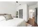 Bright bedroom with hardwood floors, neutral decor, and a glimpse into the hallway at 12 Becker Nw Pl, Atlanta, GA 30307