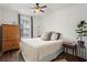 Cozy bedroom with a comfy bed, hardwood floors, and natural light from the window at 12 Becker Nw Pl, Atlanta, GA 30307