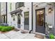 Townhome exterior featuring inviting entryways, manicured landscaping, and walkway at 12 Becker Nw Pl, Atlanta, GA 30307
