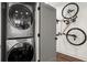 Laundry room with a stacked washer/dryer, and a bicycle rack for storage at 12 Becker Nw Pl, Atlanta, GA 30307